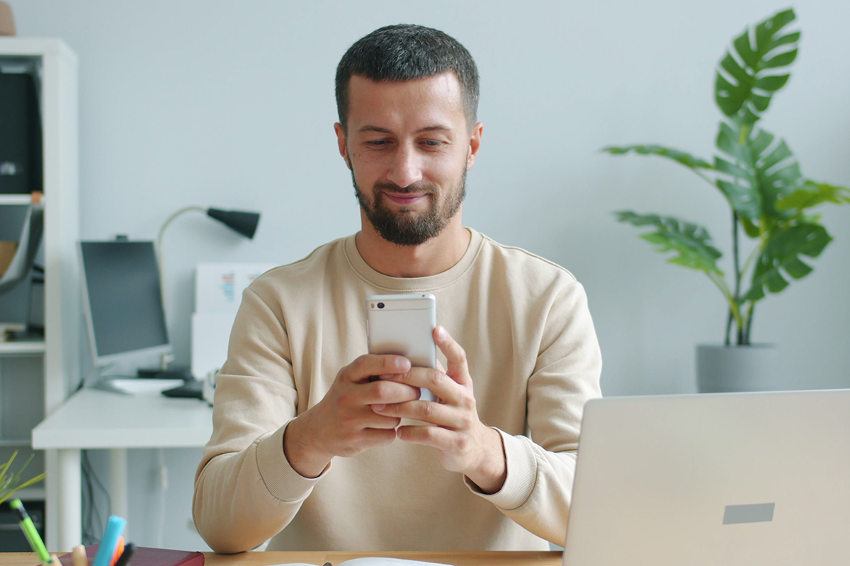 Man managing dental benefits on phone 1200x800.png