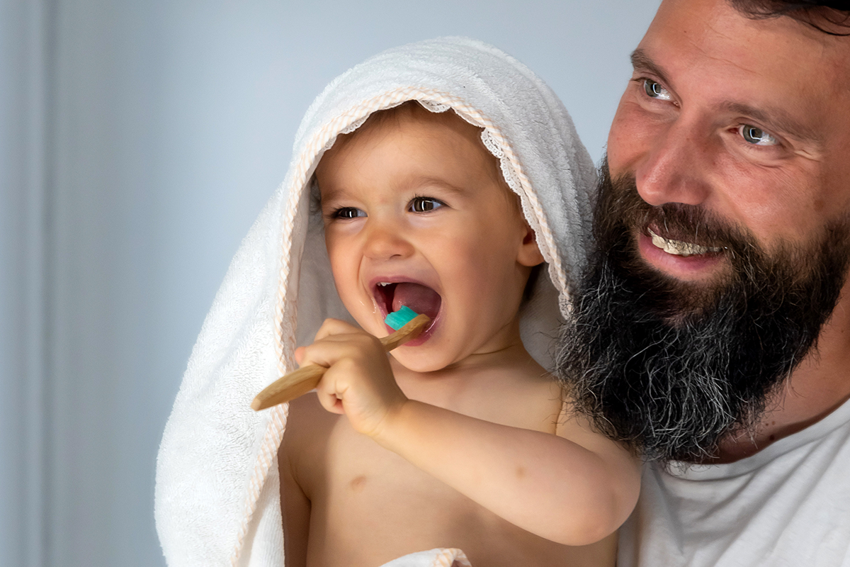 Parent with child brushing teeth 1200x800.png