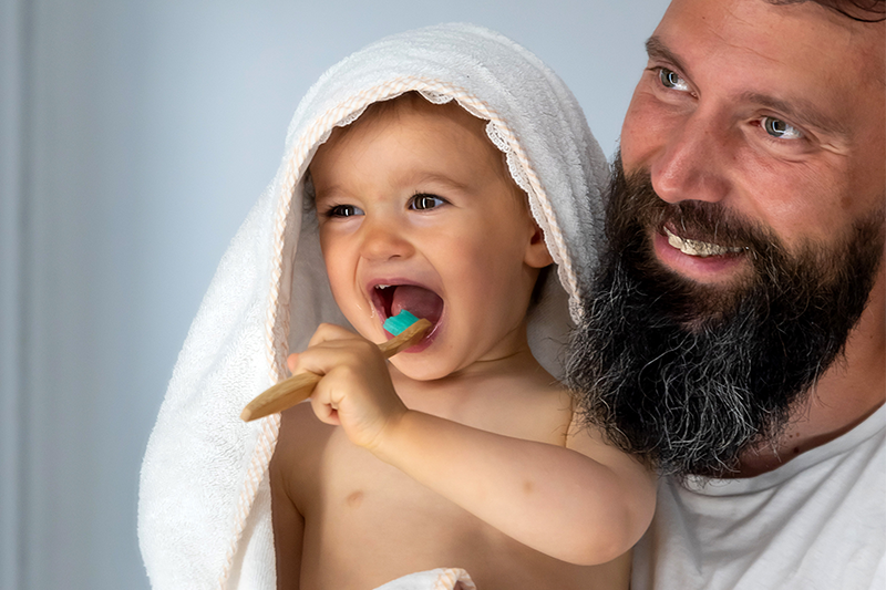 Parent with child brushing teeth 800x533.png